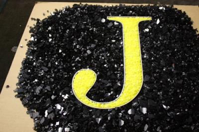 Water jet cut logos designed with fire glass