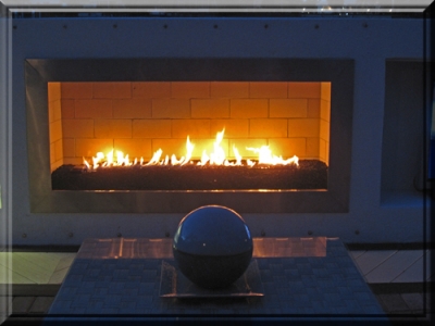 outdoor propane fireplace feature with lava rock and custom ribbon burner 4